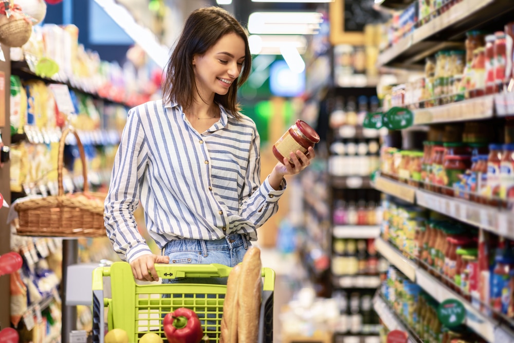 woman reading label on food can